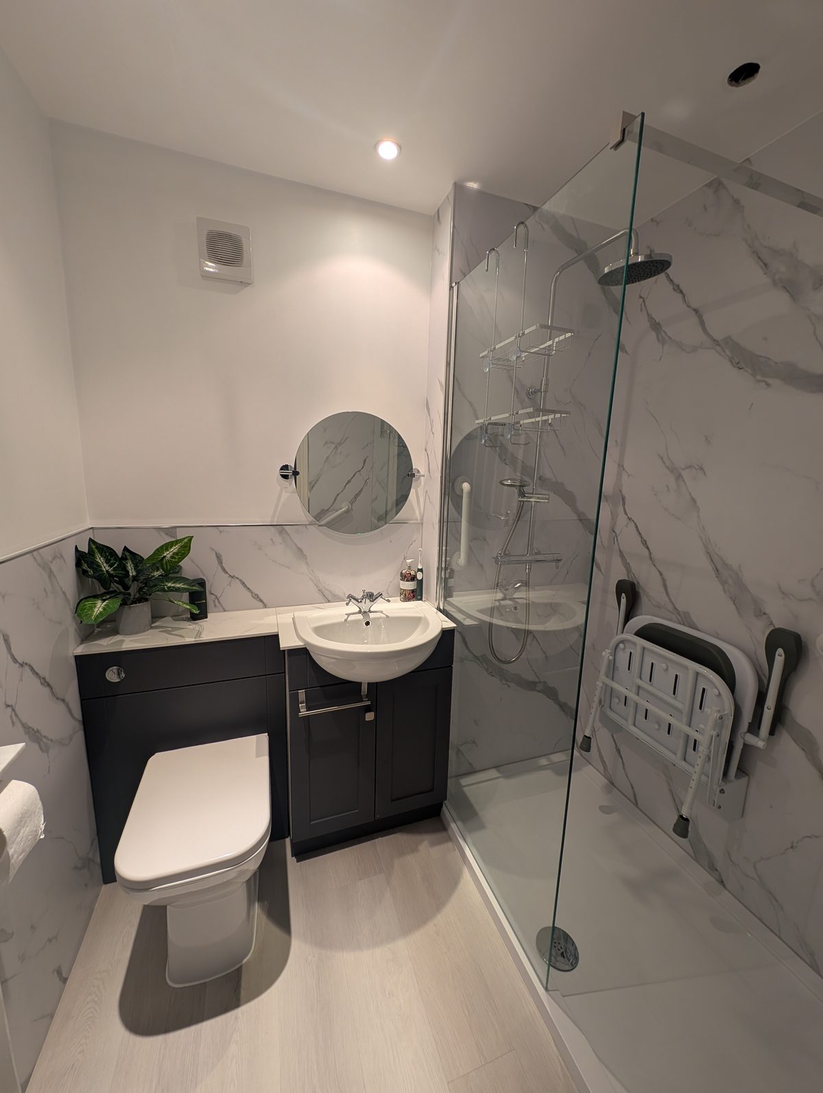 Walk-in shower room with a fold-down seat